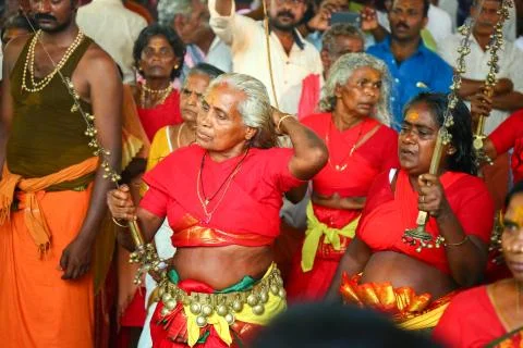 A frenzied mob of devotees led by oracles walk around the temple Stock Photos