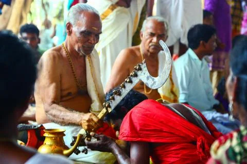A frenzied mob of devotees led by oracles walk around the temple Stock Photos