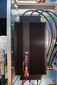 Frequency converter inside electrical cabinet showing cables and cooling fins Stock Photos