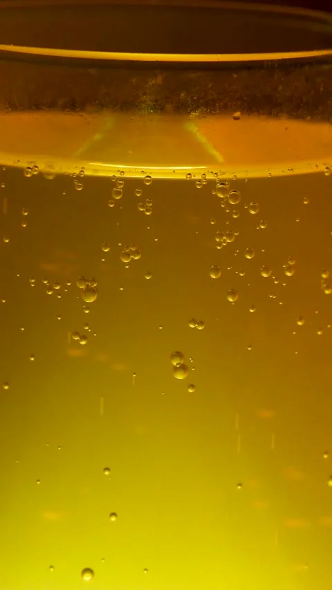 Fresh alcoholic beverage with carbonation effect in yellow liquid Stock Footage 334345355