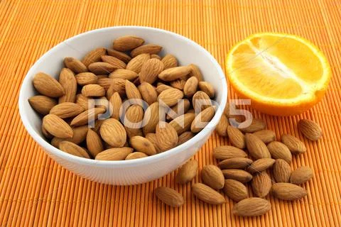 Fresh almonds and orange Stock Photos