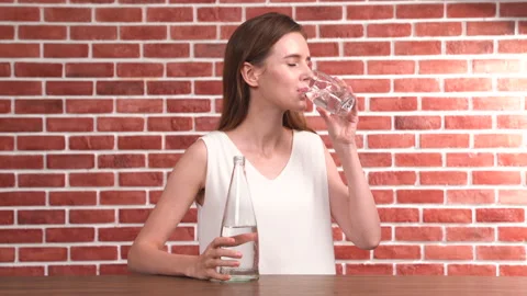 Fresh and clean drinking water being poured from jug into glass Stockbeeldmateriaal 143054028