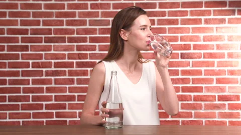 Fresh and clean drinking water being poured from jug into glass Stock Footage 143581906
