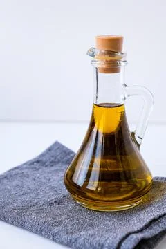 Fresh and delicious olive oil on kitchen towel. Ingredients for food cooking. Stock Photos
