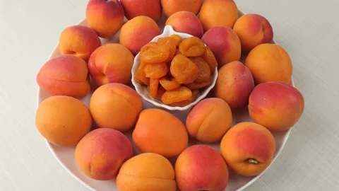 Fresh and dried apricots on a rotating plate Stock Footage 344896879