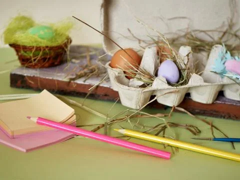 Fresh and Easter painted chicken and quail eggs in a packing tray on  table Stock Photos