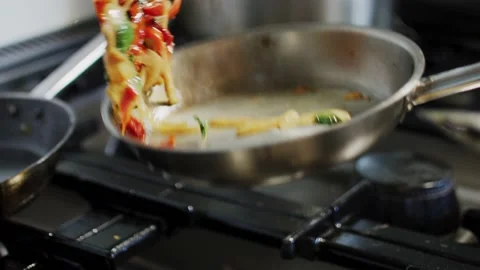 Fresh and hot food getting prepared in kitchen slow motion Stock Footage