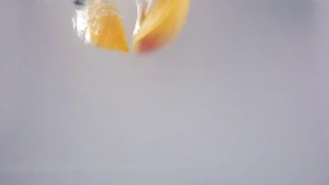 Fresh and Ripe Organic Apricots Falling Into Water Stock Footage