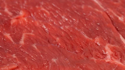Fresh angus beef steak slow rotating, low angle. Uncooked meat surface Stock Footage 121171245