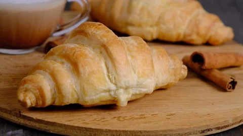 Fresh appetizing croissants and coffee on wood background, delicious breakfast Stock Footage 167282718