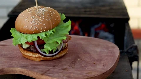 Fresh appetizing hamburger rotating on the grill background. Stock Footage 165171696