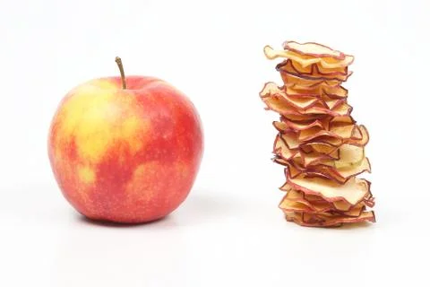 Fresh Apple and a stack of dried Apple slices on white background 스톡 사진