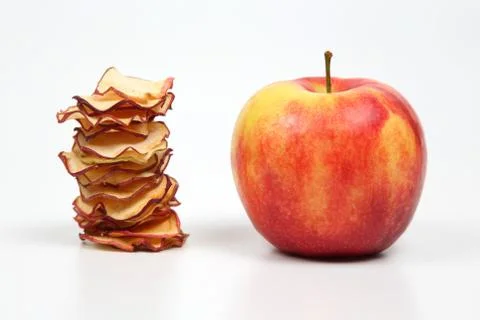 Fresh Apple and a stack of dried Apple slices on white background 스톡 사진