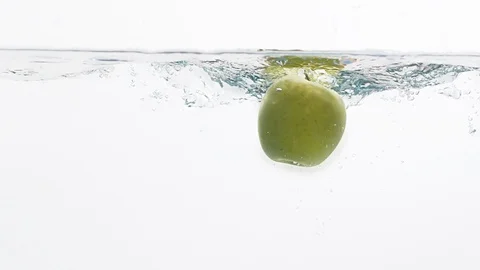 Fresh apple falling in a water Stock Footage 99724373
