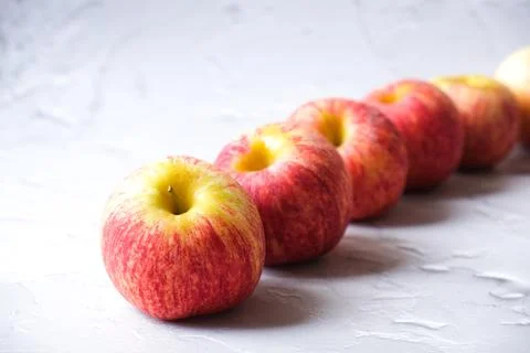 Fresh Apple lining up with white background Stock Photos