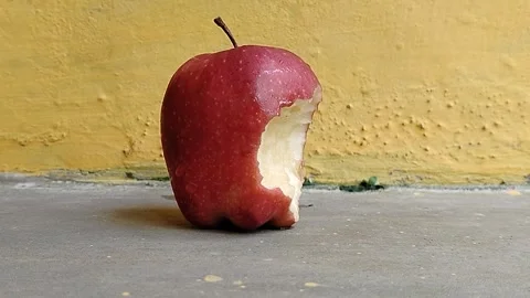 Fresh apple with a visible bite mark on the side, symbolizing taste, freshness Stock Footage 337913579