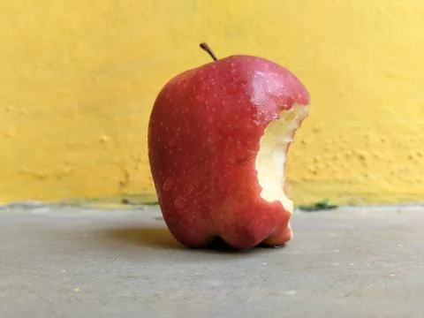 Fresh apple with a visible bite mark on the side, symbolizing taste, freshness Stock Photos