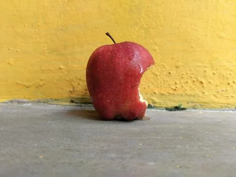 Fresh apple with a visible bite mark on the side, symbolizing taste, freshness Stock Photos