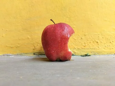 Fresh apple with a visible bite mark on the side, symbolizing taste, freshness,  写真素材