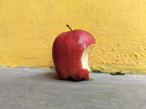 Fresh apple with a visible bite mark on the side, symbolizing taste, freshness,  Stock Photos