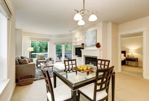 Fresh apples on modern dining table . Open floor plan. Apartment interior. No Stock Photos