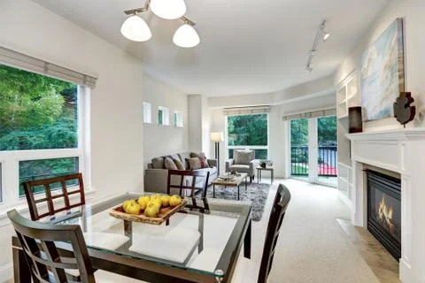 Fresh apples on modern dining table . Open floor plan. Apartment interior. No Stock Photos