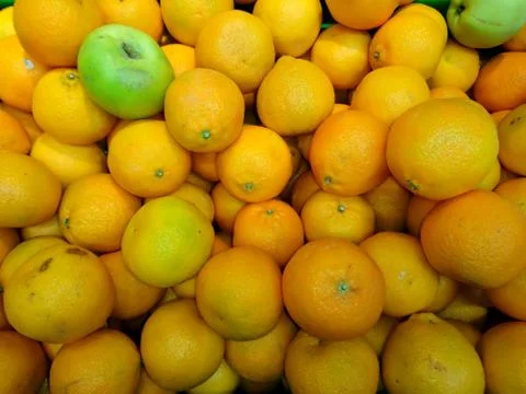 Fresh apples with oranges close-up Stock Photos