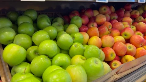 Fresh apples piled on store shelves in natural light. The vibrant produce Stock-Footage 317316616