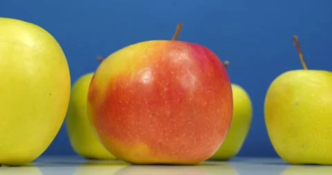 Fresh apples rotates on blue backdrop Stock Footage 321971271