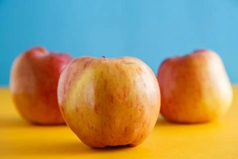 Fresh apples on yellow-blue background Stock Photos