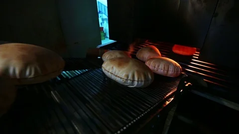 Fresh Arabic bread coming out of the oven Stock Footage 121964151