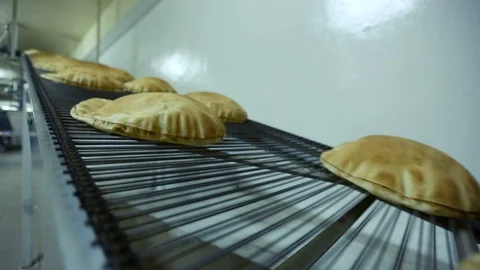 Fresh Arabic bread coming out of the oven Stock Footage 121964302