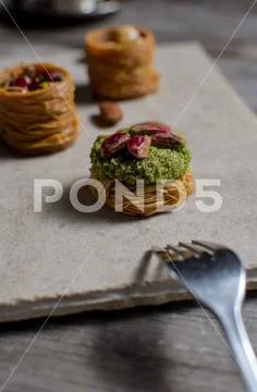 Fresh arabic sweets on light stone background. Stock Photos