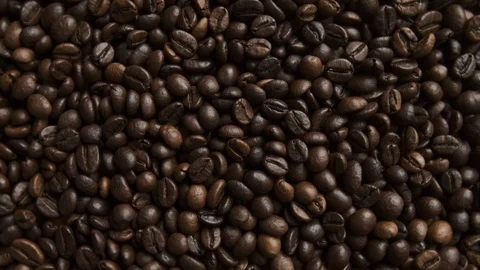 Fresh aromatic coffee beans rotating. Top down, overhead shot. Stock Footage 116665737