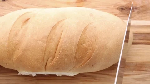 Fresh Artisan Bread Being Sliced On Wooden Cutting Board Stock Footage 308827707