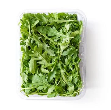 Fresh arugula in plastic container isolated on white, from above Stock Photos