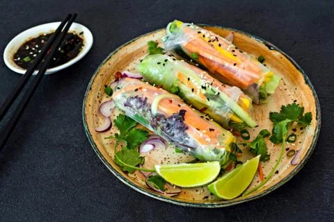 Fresh Asian appetizer Spring rolls (Nem) made from rice paper and raw vegetables Stock Photos