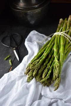 Fresh Asparagus tied bundle in rustic setting Stock Photos