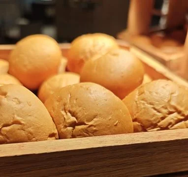 Fresh Assorted Bread Rolls and Buns Displayed in Wooden Bakery Tray Stock Photos