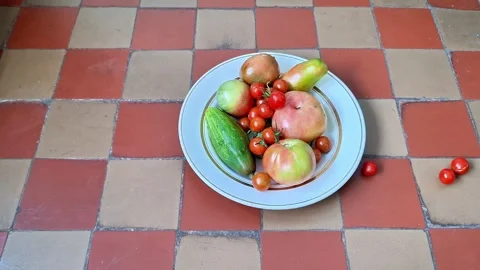 Fresh Assorted Tomatoes and Cucumbers Arranged in a Bowl for Cooking Stock Footage 344928151