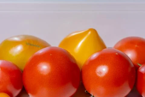 Fresh assorted tomatoes including red, yellow, and orange varieties arrange.. Stock Photos