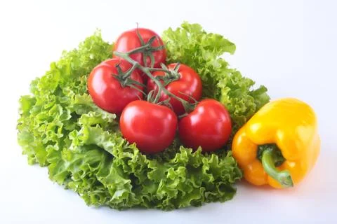 Fresh assorted vegetables bell pepper, tomato, garlic with leaf lettuce Stock Photos