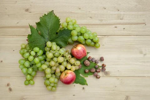 Fresh autumn fruit on rustic light wooden background Stock Photos