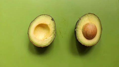 A fresh avocado is cut in half 库存影片 143559465