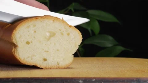 Fresh baguette, fresh bread, slicing bread, guy slicing bread Stock Footage 264885274