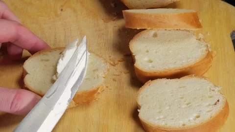 Fresh baguette, fresh bread, spread cottage cheese on bread Stock Footage 264885638