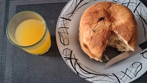 Fresh baked bread and orange juice in breakfast motion video footage Stock Footage 339499183