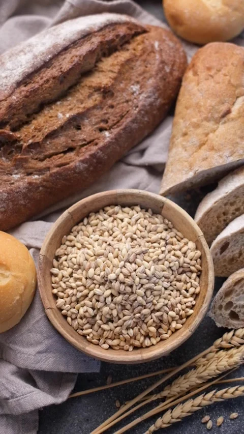 Fresh baked bread assortment and wheat grains Stock Footage 336179601