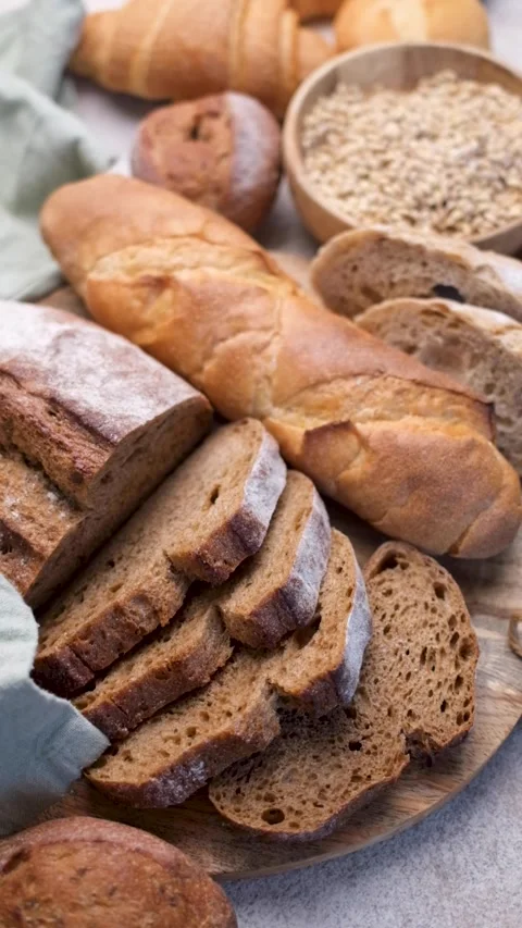 Fresh baked bread assortment on a kitchen counter Stock Footage 336179721