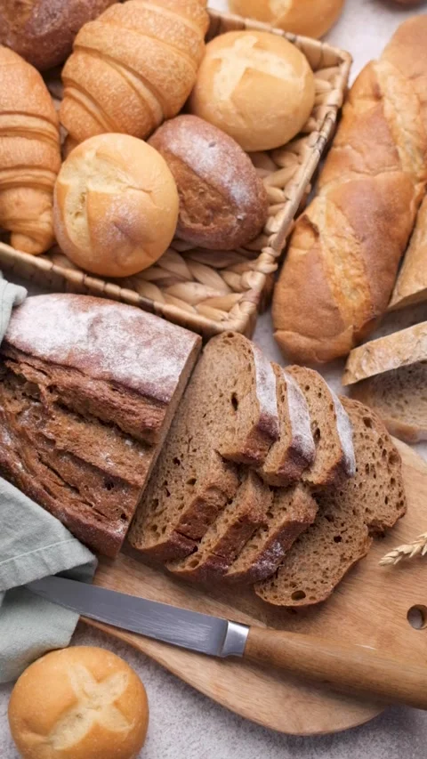 Fresh baked bread assortment on a kitchen counter Stock Footage 336677046